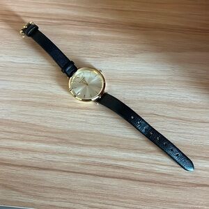 Black and gold Kate Spade New York metro watch